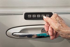 Senior woman is opening the door with keyless entry door installed by Locksmith in Austin